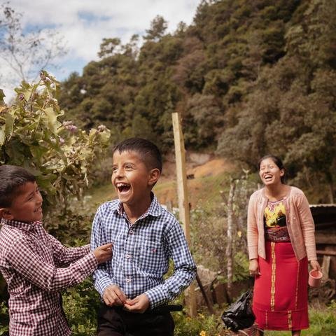 Brothers Edizon, seven, and Tomás, nine, with mum Rebeca, 27, at their farm in Quiche district, Guatemala
